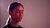 Facial Recognition Technology Concept As Woman Has Red Grid Projected Onto Face In Studio