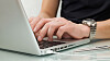 Businessman typing on a notebook (shallow DOF, hand in focus)