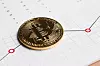 Coin crypto currency bitcoin against the background of a changing chart subject gold exchange pyramid for money in connection with the growth or fall exchange rate closeup.