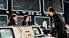 Scene fra WarGames-filmen med skuespillerne Ally Sheedy, Mathew Broderick og John Wood. I bakgrunnen sees noen av de store skjermene til WOPR-datamaskinen til NORAD.