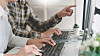 Pensive programmer working on desktop pc programming code technologies or website design at office S ...