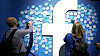 FILE - In this Tuesday, April 30, 2019 file photo, attendees stick notes on a Facebook logo at F8, the Facebook's developer conference, in San Jose, Calif. Facebook lost a legal battle Friday, May 14, 2021 with Ireland's data privacy watchdog over a European Union privacy decision that could result in the social network being forced to stop transferring data to the U.S. The Irish High Court rejected Facebook's bid to block a draft decision by the country's Data Protection Commission to inquire into, and order the suspension of, the company's data flows between the European Union and the U.S. (AP Photo/Tony Avelar, file)