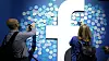 FILE - In this Tuesday, April 30, 2019 file photo, attendees stick notes on a Facebook logo at F8, the Facebook's developer conference, in San Jose, Calif. Facebook lost a legal battle Friday, May 14, 2021 with Ireland's data privacy watchdog over a European Union privacy decision that could result in the social network being forced to stop transferring data to the U.S. The Irish High Court rejected Facebook's bid to block a draft decision by the country's Data Protection Commission to inquire into, and order the suspension of, the company's data flows between the European Union and the U.S. (AP Photo/Tony Avelar, file)