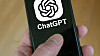 ChatGPT Open AI logo on smartphone screens held in hand. Copenhagen, Denmark - January 25, 2025.