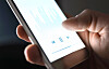 Listening to podcast, music or audiobook with mobile phone. Man using streaming service and smartphone app with audio player and equalizer. Person holding cellphone in hand.