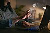 Computer Concept With Artificial Intelligence AI Overlay Projected Onto Screen Of Woman Using Laptop