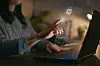Computer Concept With Artificial Intelligence AI Overlay Projected Onto Screen Of Woman Using Laptop